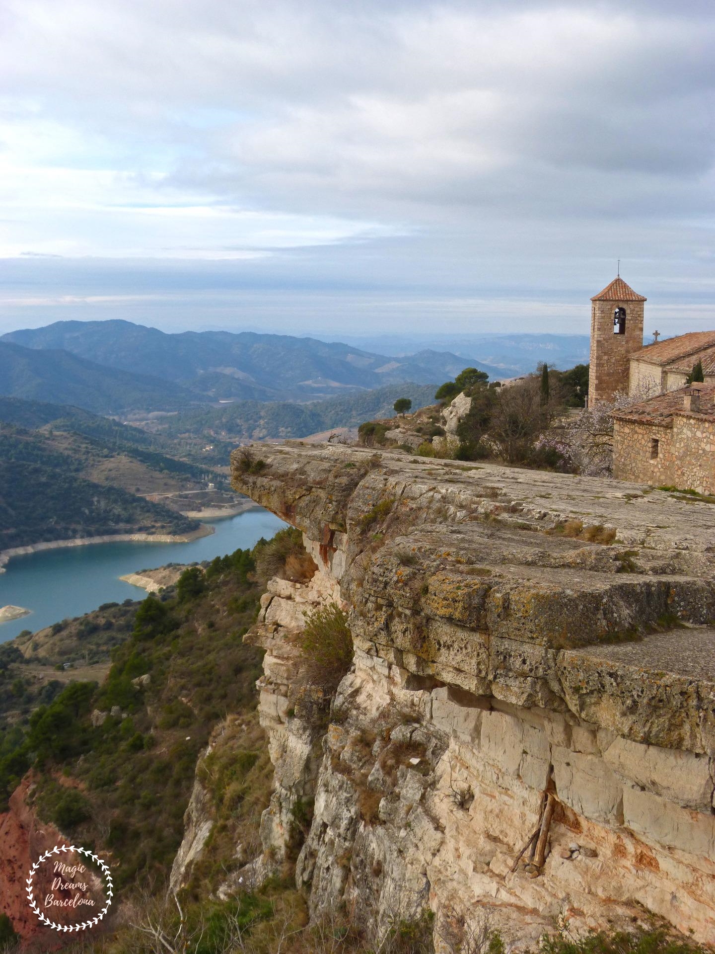 Detalle del campanario de Iglesia de Santa María en Siurana con el embalse de fondo.